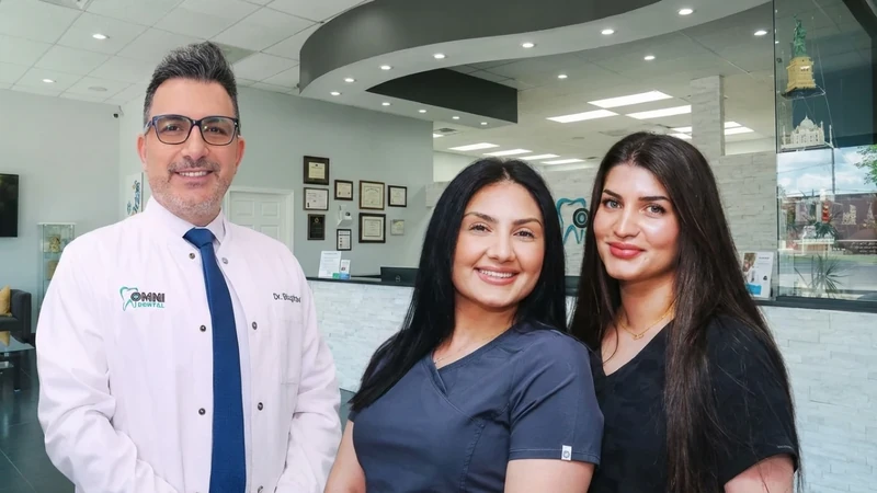Dr. Bilus Poles with two team members in the office at Omni Dental in Arlington Heights