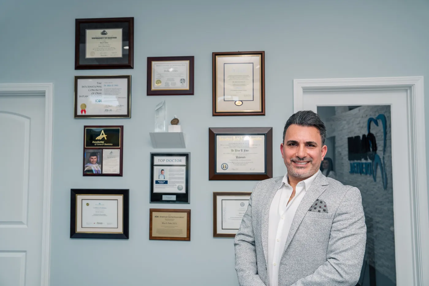 Dr. Bilus Poles beside his credentials in Arlington Heights, IL
