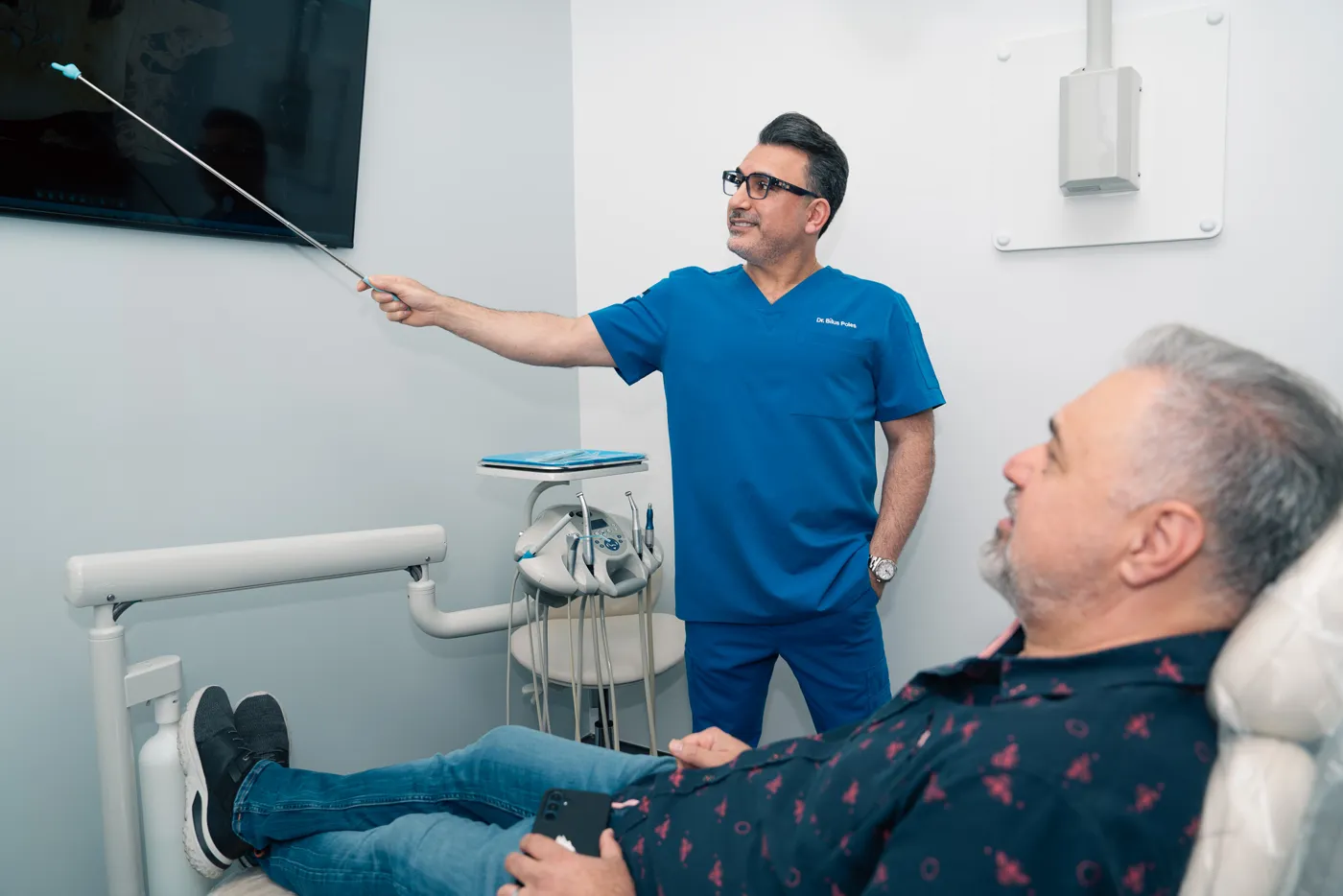 Dr. Bilus Poles reviewing tooth images with a patient for deep internal stains, Arlington Heights, IL